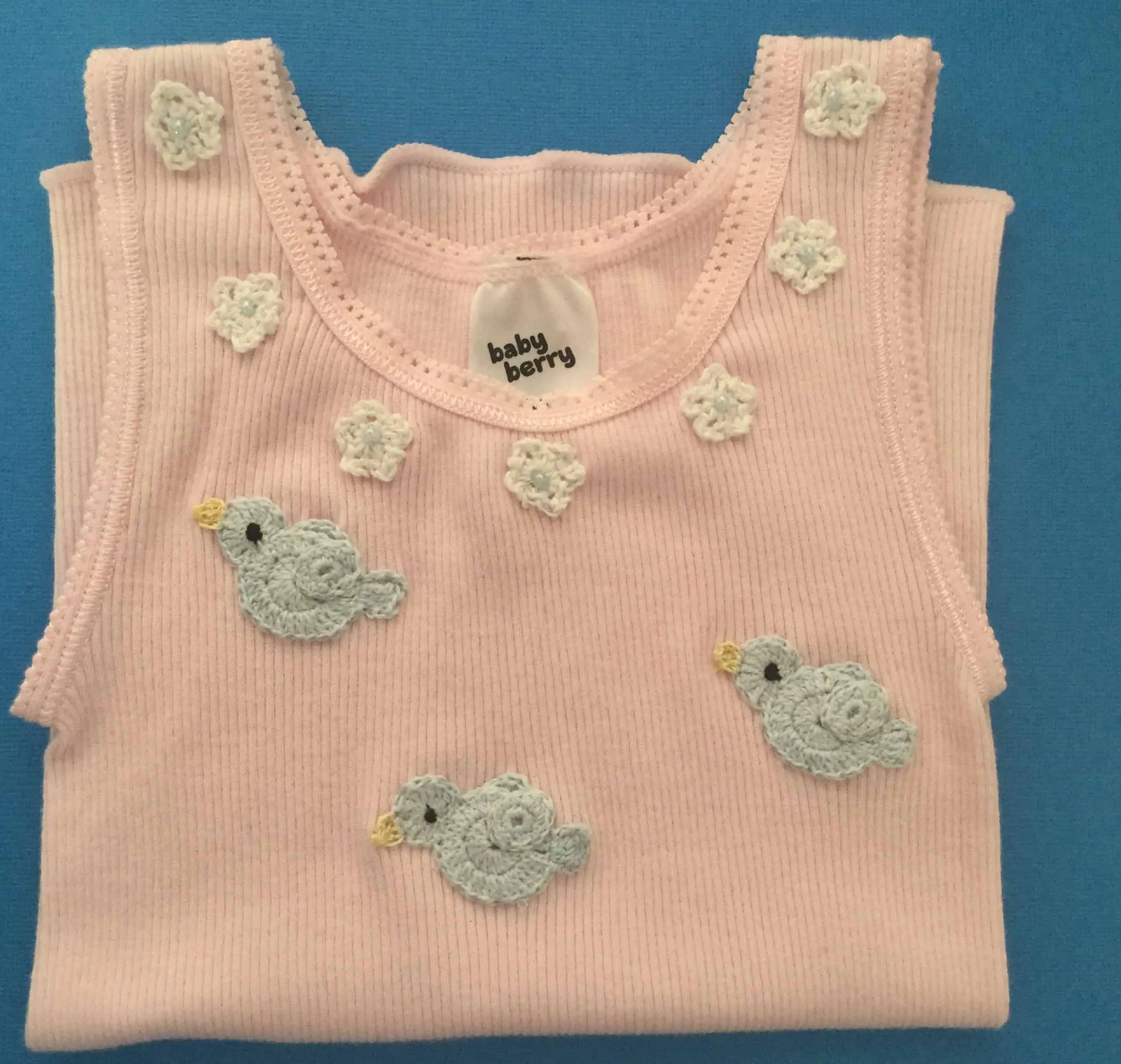 Crochet baby singlet with flowers and birds, landscape