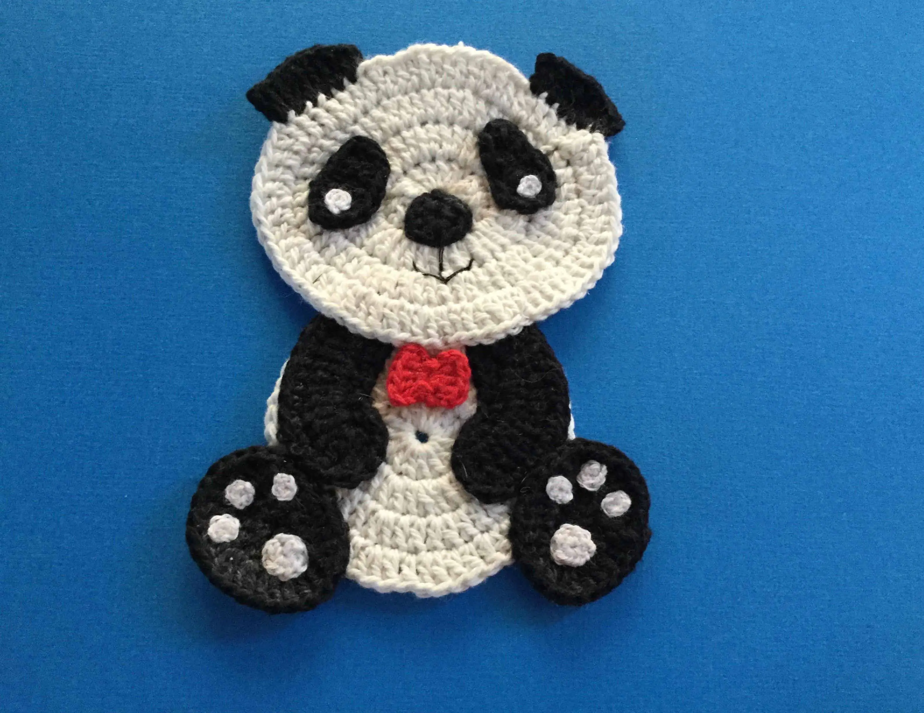 Finished crochet panda with bowtie landscape