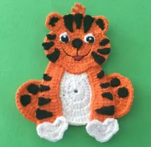 Crochet crouching tiger body with paws