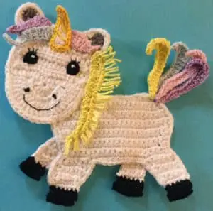 Crochet unicorn body with first mane piece