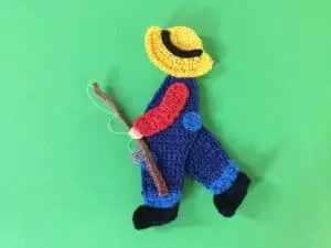 Finished crochet boy with a fishing rod landscape