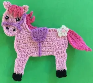 Crochet rocking horse body with flower