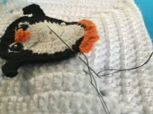 Attaching appliques to items sewing on penguin