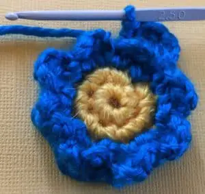 Crochet flower for granny square first petal row three