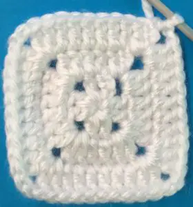 Crochet solid granny square row three finished