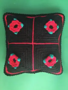 Finished crochet flower cushion black portrait
