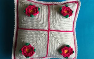 Finished cushion with joined granny squares landscape