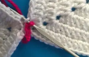 Joining granny square with slip stitch hook in through outer loop of first and second granny square