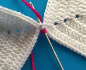 Joining granny square with slip stitch hook into outer loop of second granny square