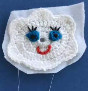 Crochet cloud finger puppet on felt