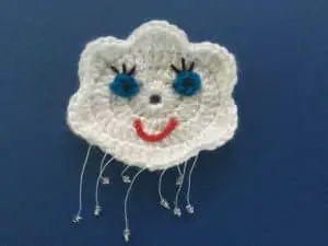 Finished crochet cloud finger puppet with felt landscape