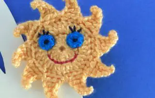 Finished crochet sun finger puppet landscape