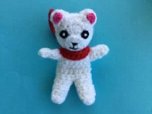 Finished crochet teddy for plane mobile with scarf landscape