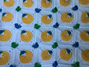 Finished Crochet spring blanket cushion closeup