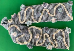 Crochet flower scarf pinned on