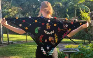 Finished crochet shawl with model landscape