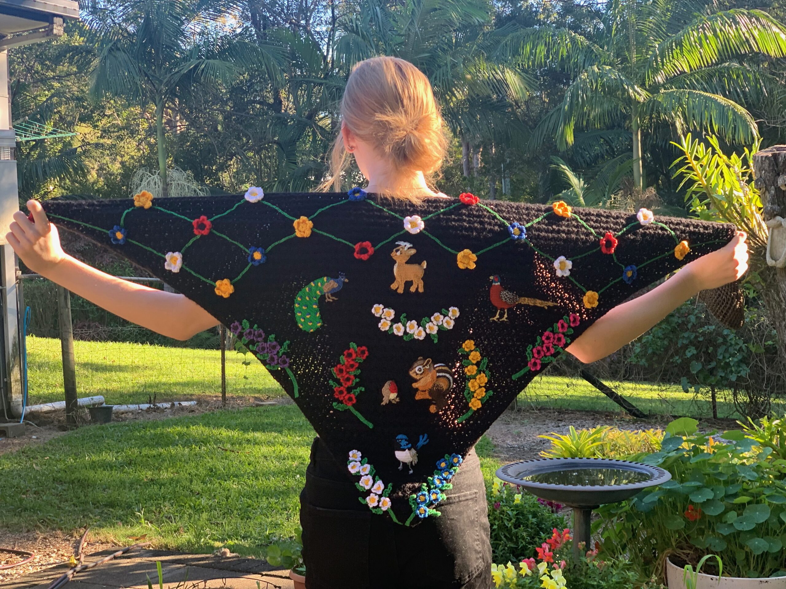 Finished crochet shawl with model landscape