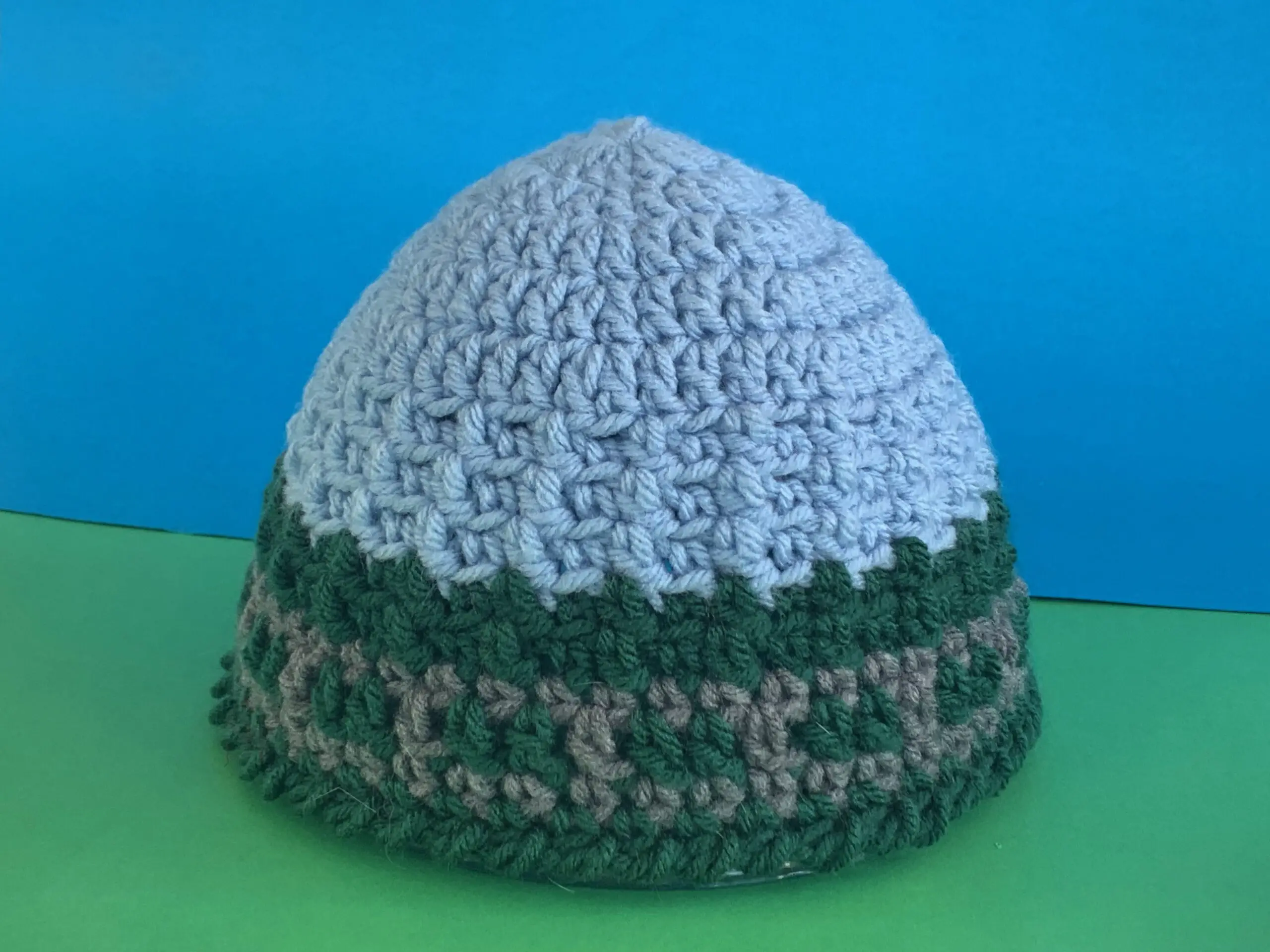 Finished train track beanie green and blue background landscape