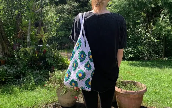 Finished crochet granny square shopping bag white with model landscape