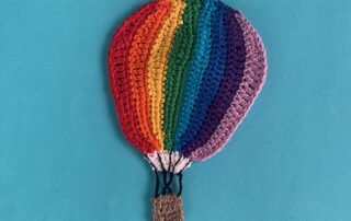 Finished crochet hot air balloon 2 ply light background landscape