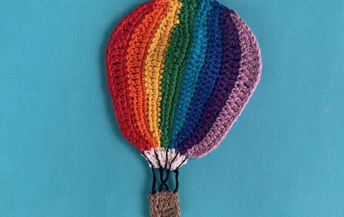 Finished crochet hot air balloon 2 ply light background landscape