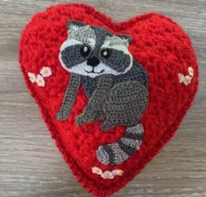 Crochet heart raccoon