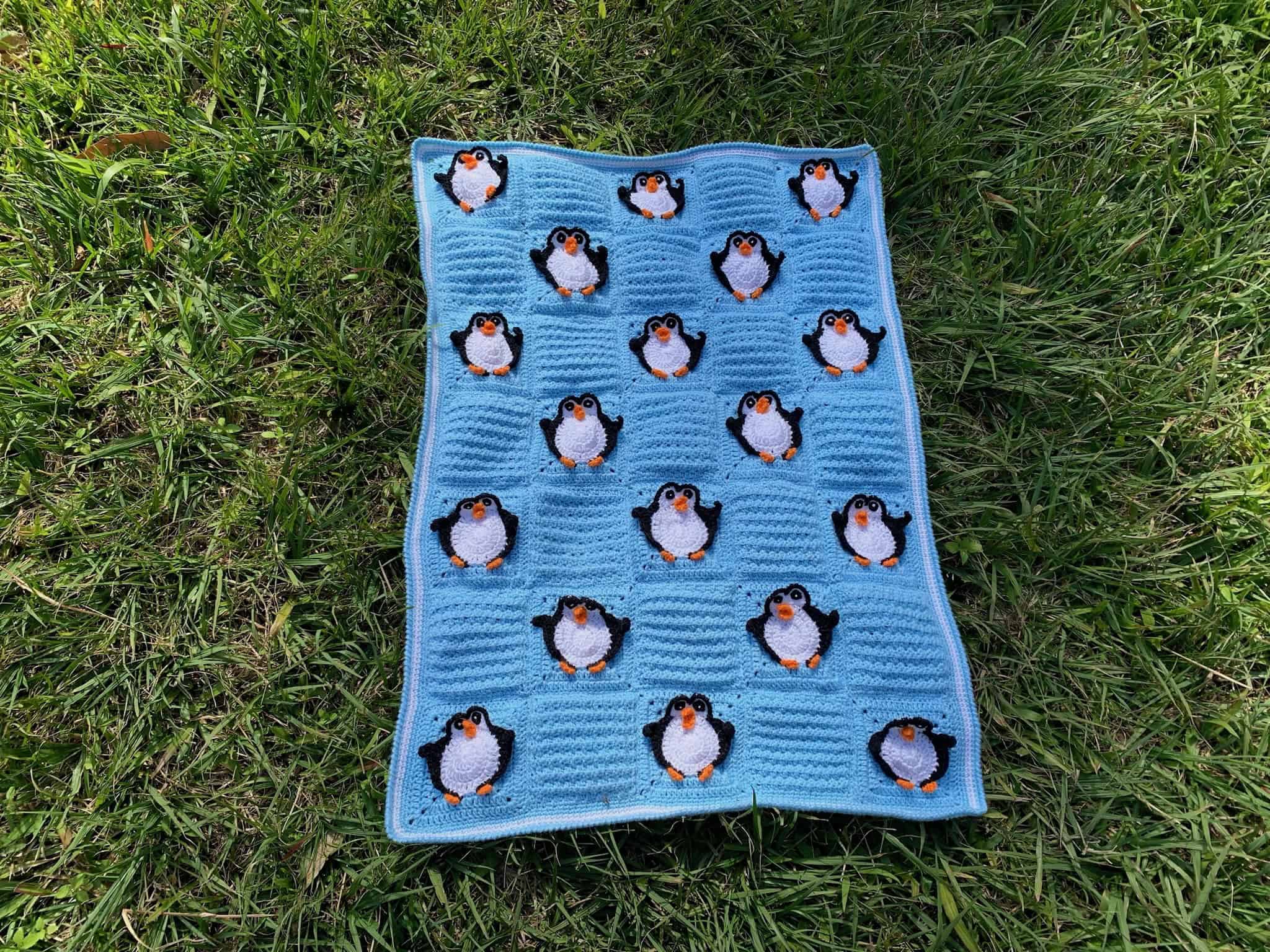 Finished crochet penguin baby blanket landscape grass