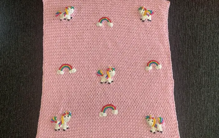 Finished crochet unicorn baby blanket landscape