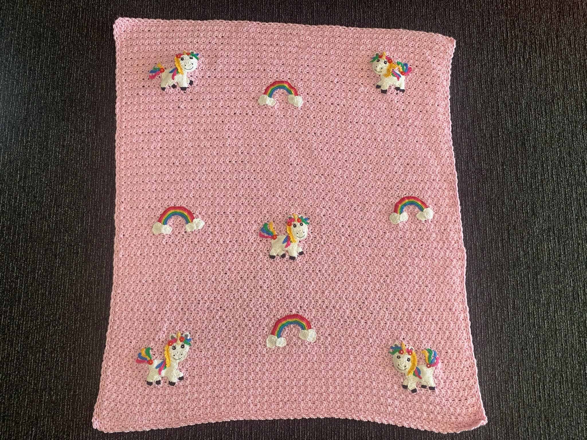 Finished crochet unicorn baby blanket landscape